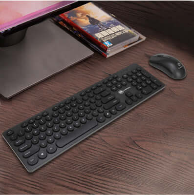 Punk keyboard and mouse set in black on a wooden desk, featuring a mute keyboard design and USB interface.