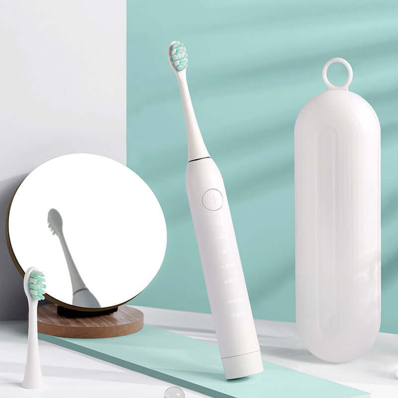 Sleek electric toothbrush with charging case and mirror, showcasing modern design in white and mint green.