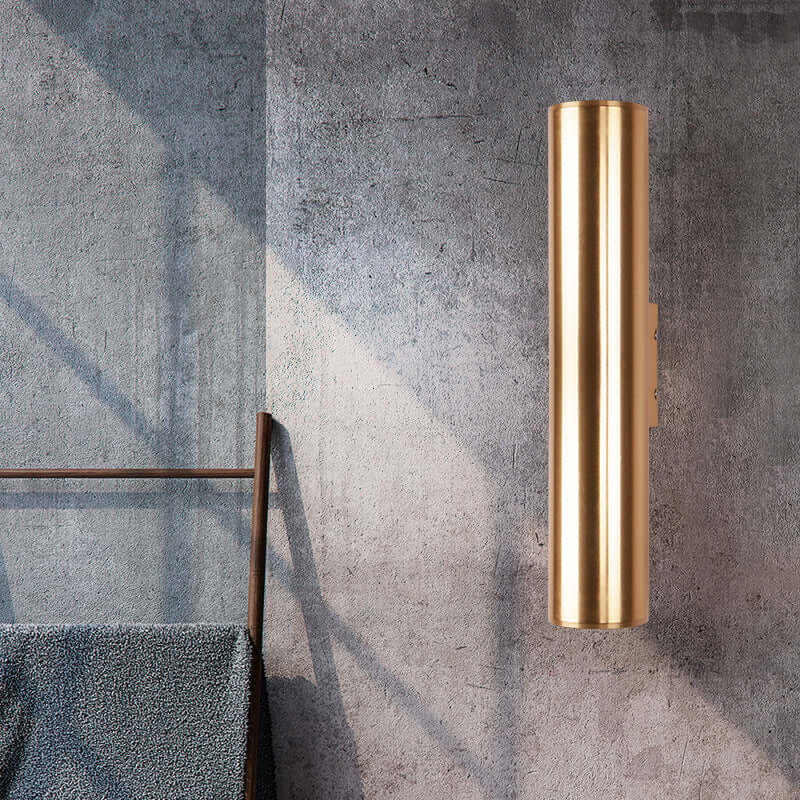 Contemporary gold wall lamp on gray wall, perfect for modern decor and LED lighting, stylish and functional design.