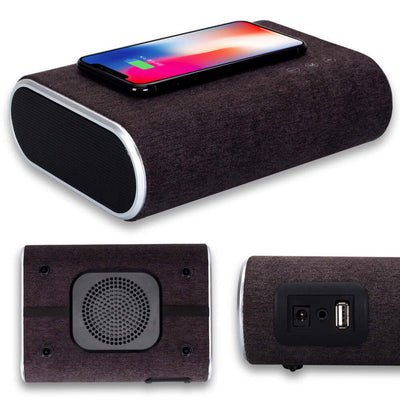Wireless charger speaker in dark brown, featuring Bluetooth capabilities and a phone charging on top.