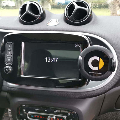 Car interior featuring a wireless charger mounted on dashboard with clock display, perfect for easy wireless charging.