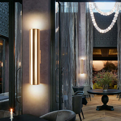 Iron vintage wall lamp illuminating a stylish dining area with modern decor and soft lighting.