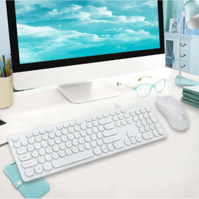 Punk white keyboard and mouse set on a modern desk with an ocean view screen, ideal for general use, USB interface.