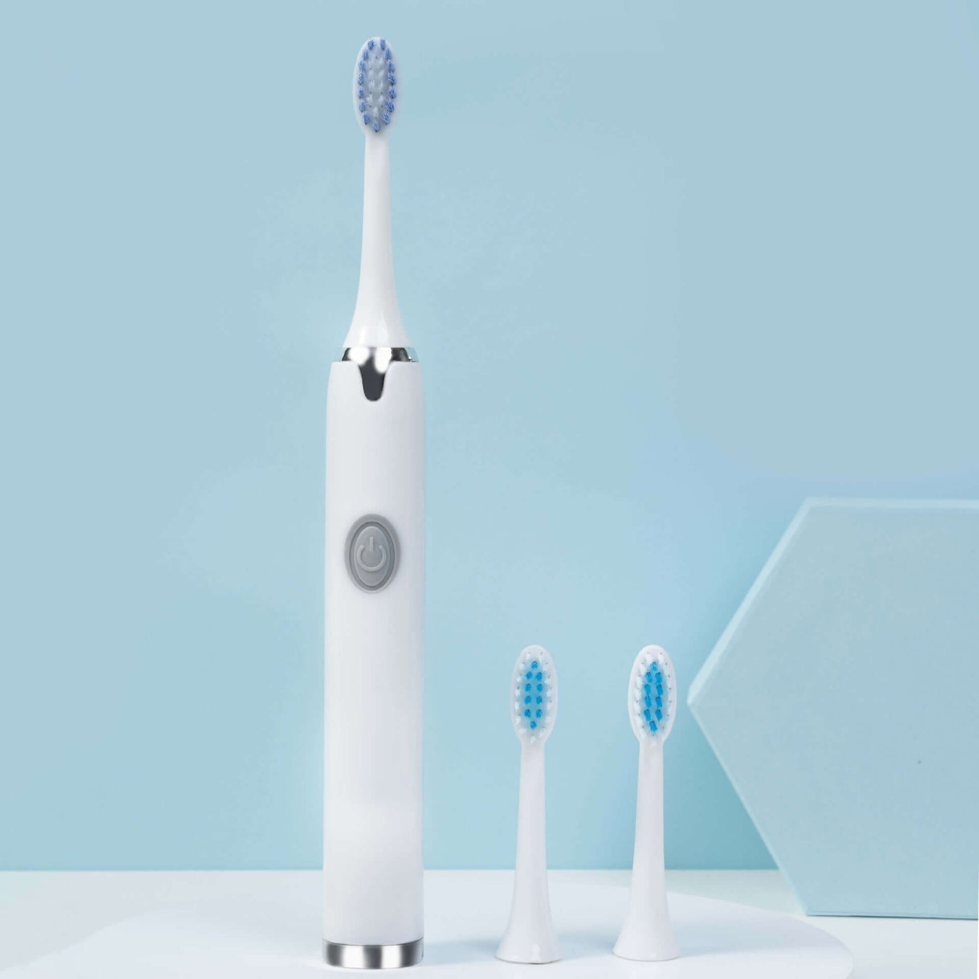 Rechargeable waterproof electric toothbrush with two additional brush heads, ideal for effective self-cleaning.