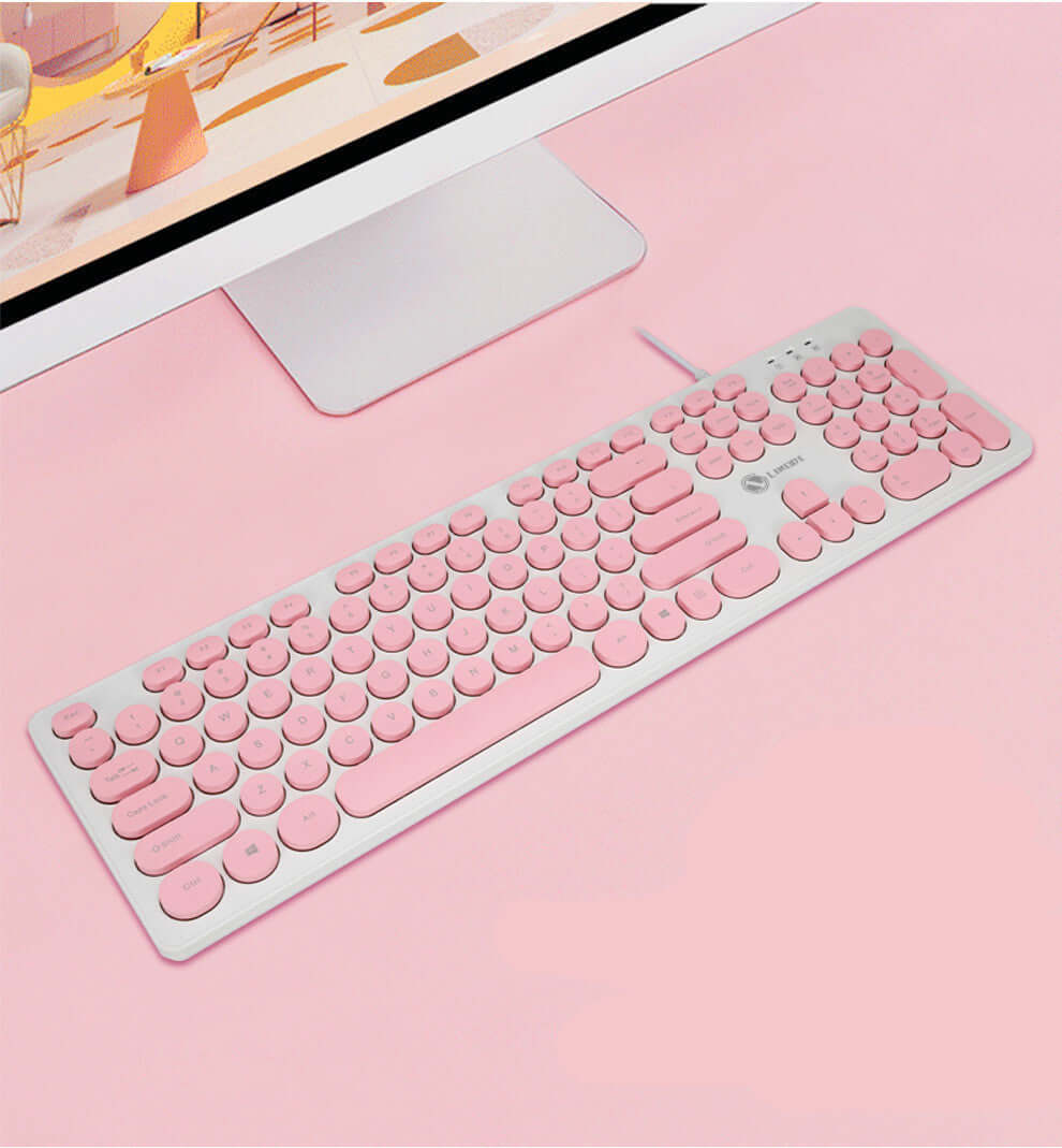 Pink mute keyboard with round keys on a light background, perfect for stylish home or office setups.