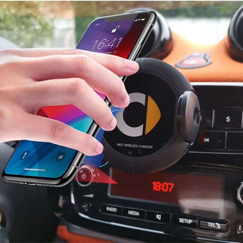 Car wireless charger with smartphone being attached, featuring fast wireless charging in a stylish dashboard mount.