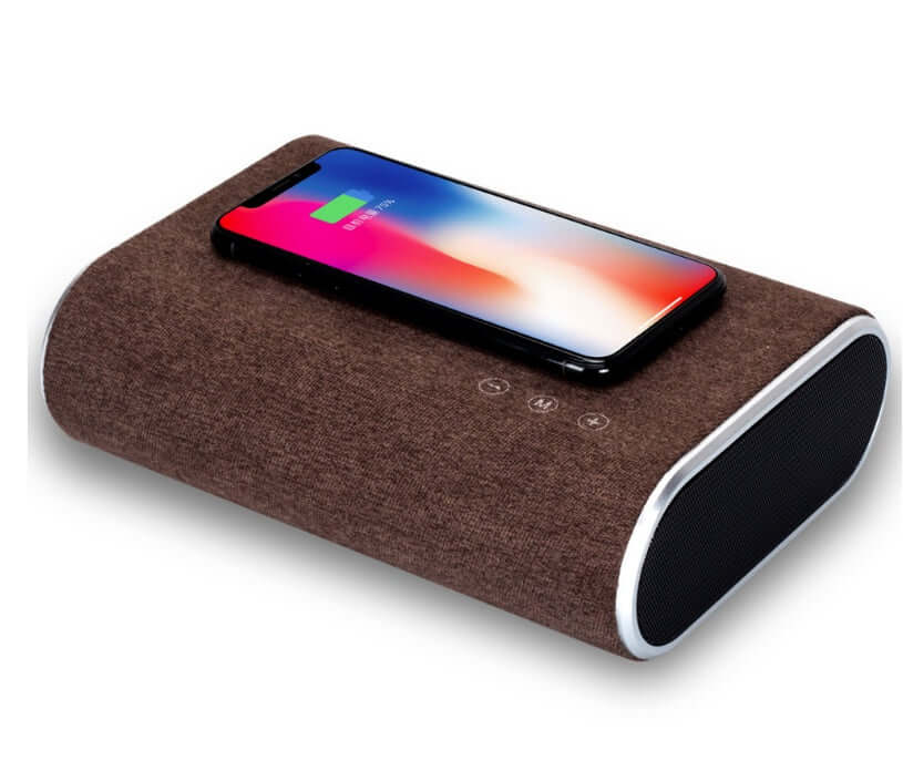 Wireless charger speaker in dark brown with smartphone on top, showcasing Bluetooth music streaming and charging.