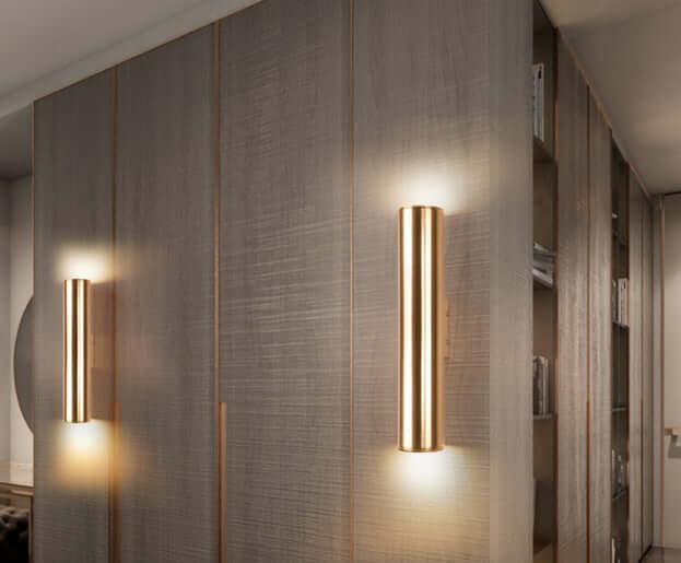 Sleek modern wall lamps illuminating a stylish wooden cabinet in a contemporary interior space.