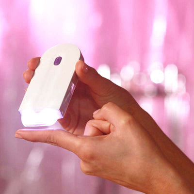Painless hair remover tool head accessory held in hand, featuring a compact design and illuminating light, perfect for easy hair removal.