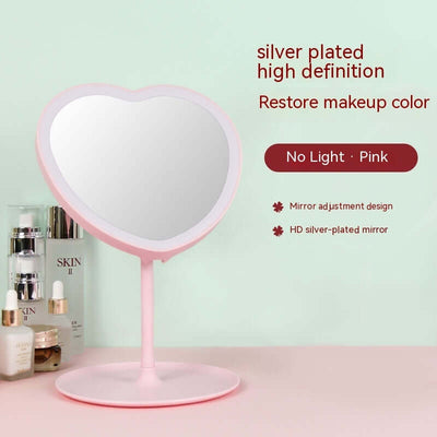 Heart-shaped pink cosmetic mirror with silver plating, designed to restore makeup color and featuring an adjustable stand.