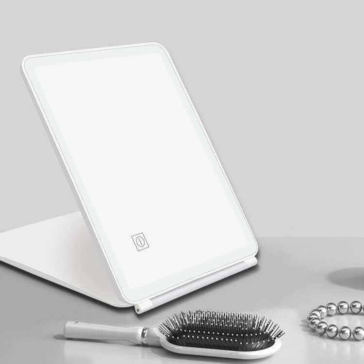 Clamshell desktop LED touch dressing mirror with light in white, ideal for bedroom and bathroom use.