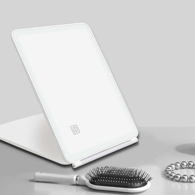 Clamshell desktop LED touch dressing mirror with light in white, ideal for bedroom and bathroom use.