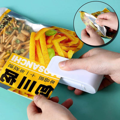 Hand using a Mini Heat Sealer to securely seal a food bag, ensuring freshness for snacks and leftovers.