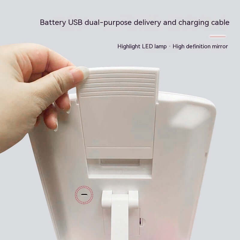 Battery USB dual-purpose feature of the LED folding makeup mirror, showcasing the charging cable and high-definition quality.