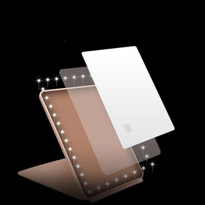 Clamshell desktop LED touch dressing mirror with light, featuring a sleek design and adjustable angles for easy use.