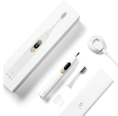 Electric toothbrush with magnetic fast charging base, accessories, and sleek packaging for effective dental care.