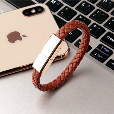 Stylish brown braided charging bracelet next to smartphone, showcasing sleek design and rapid charging technology.