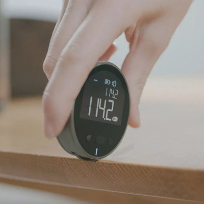 Digital measurement tape displaying accurate measurement on a wooden surface, showcasing easy usability and precision.