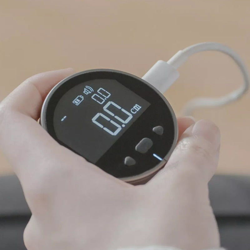 User holding a digital measurement tape with an LED screen displaying accurate measurement readings.