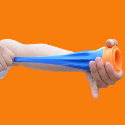 Person demonstrating the Slingshot Cup, pulling back the blue elastic band for an accurate shot.