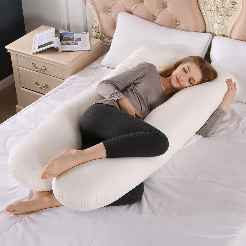Comfortable woman sleeping with a Sleep Therapy Pillow in a cozy bedroom setting.
