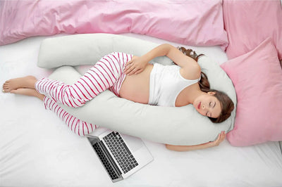 Pregnant woman resting with Sleep Therapy Pillow for support, enhancing comfort and promoting better sleep.