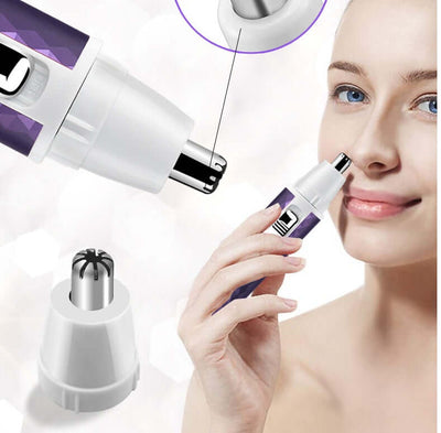Close-up of a woman using a portable electric razor for nose hair trimming with interchangeable heads.