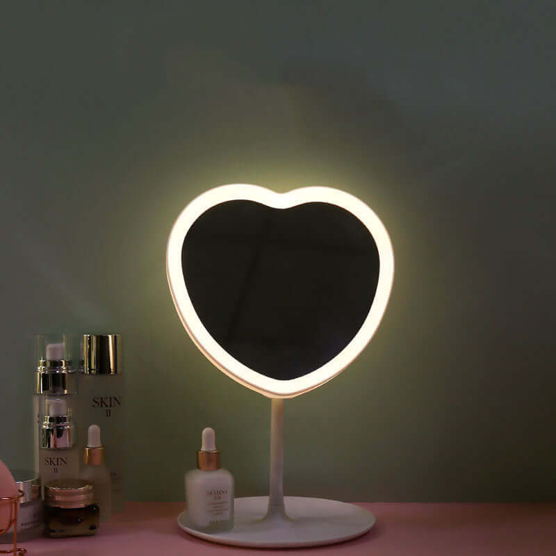 Heart-shaped LED makeup mirror with soft glow, ideal for cosmetics and beauty routines.