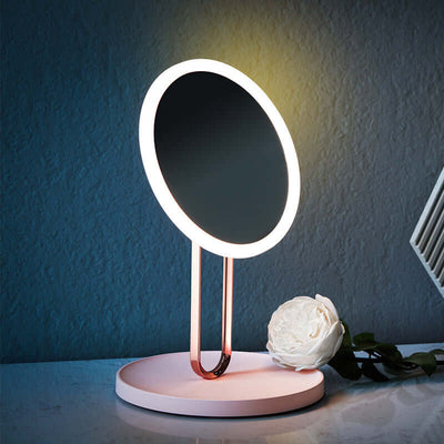 Desktop LED makeup mirror with light in cherry blossom pink, featuring a modern design with glass lens and ABS frame.