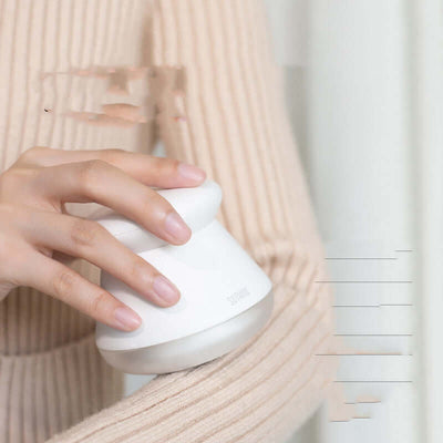 Person holding a rechargeable hair remover in white, designed for effective hair removal on clothes.