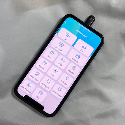 Smartphone displaying IR Phone Adapter controls for various devices like TV, air conditioner, and lights.