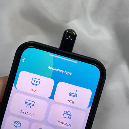 Smartphone with IR Phone Adapter showcasing control options for TV, Air Conditioner, and other appliances.