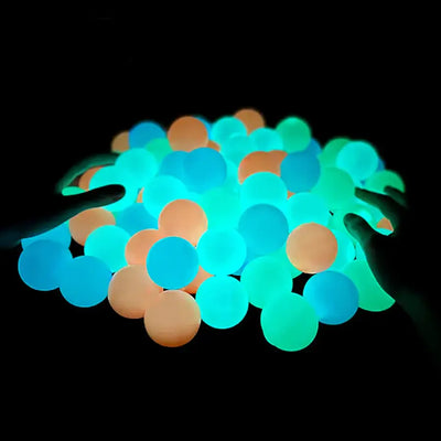 Colorful glowing sticky balls in the dark, perfect for fun and games during nighttime.