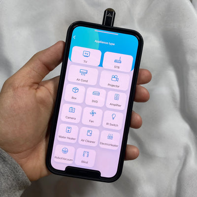 Smartphone displaying app to control various home appliances using an infrared phone adapter.