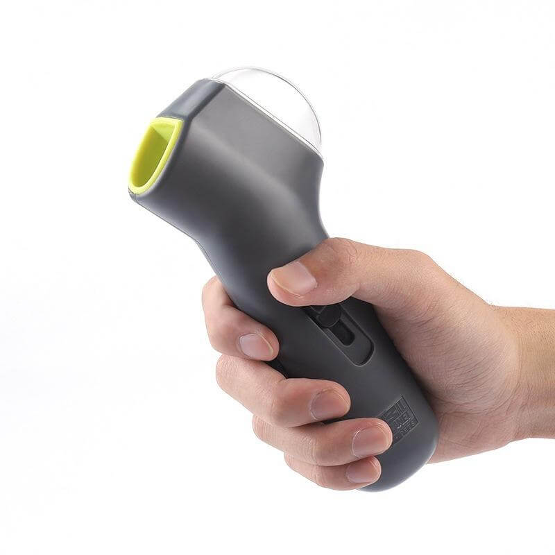 Person holding a Pet Treat Launcher in a hand, showcasing its ergonomic design and easy grip for fun dog treat dispensing.
