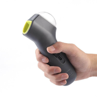 Person holding a Pet Treat Launcher in a hand, showcasing its ergonomic design and easy grip for fun dog treat dispensing.