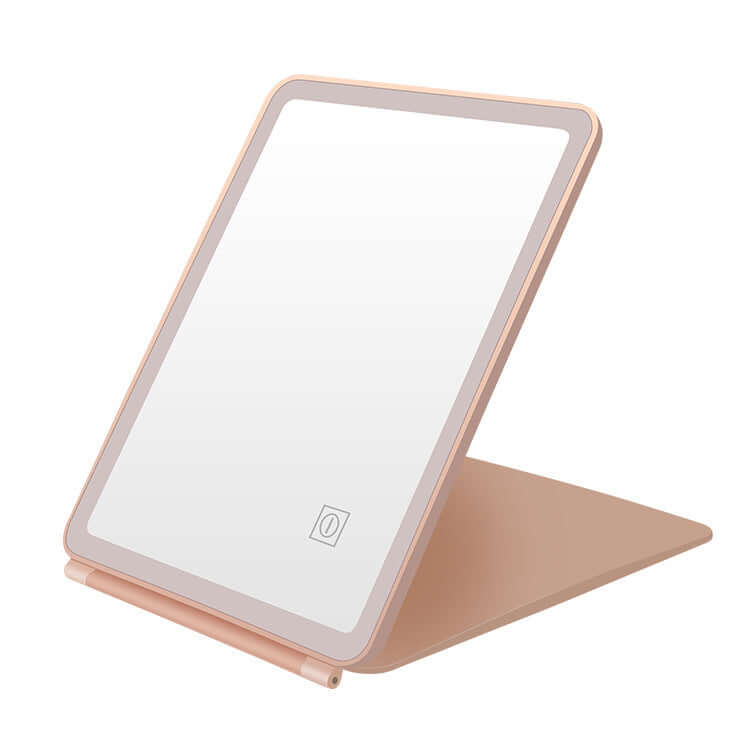 Clamshell desktop LED touch dressing mirror with light in pink, perfect for bedrooms and bathrooms.