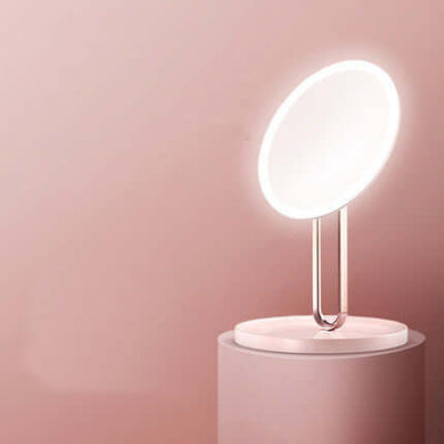 Desktop LED makeup mirror with light in cherry blossom pink, showcasing sleek design and modern functionality.