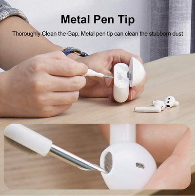Person using a metal pen tip to clean stubborn dust from AirPods in a cleaning kit.