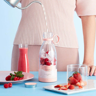 Woman using a Blender Bottle with fruit, showcasing fresh smoothies and aesthetic kitchen setup.