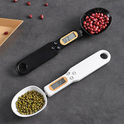 LCD digital kitchen scale spoon in black and white, displaying accurate measurements of red and green beans.