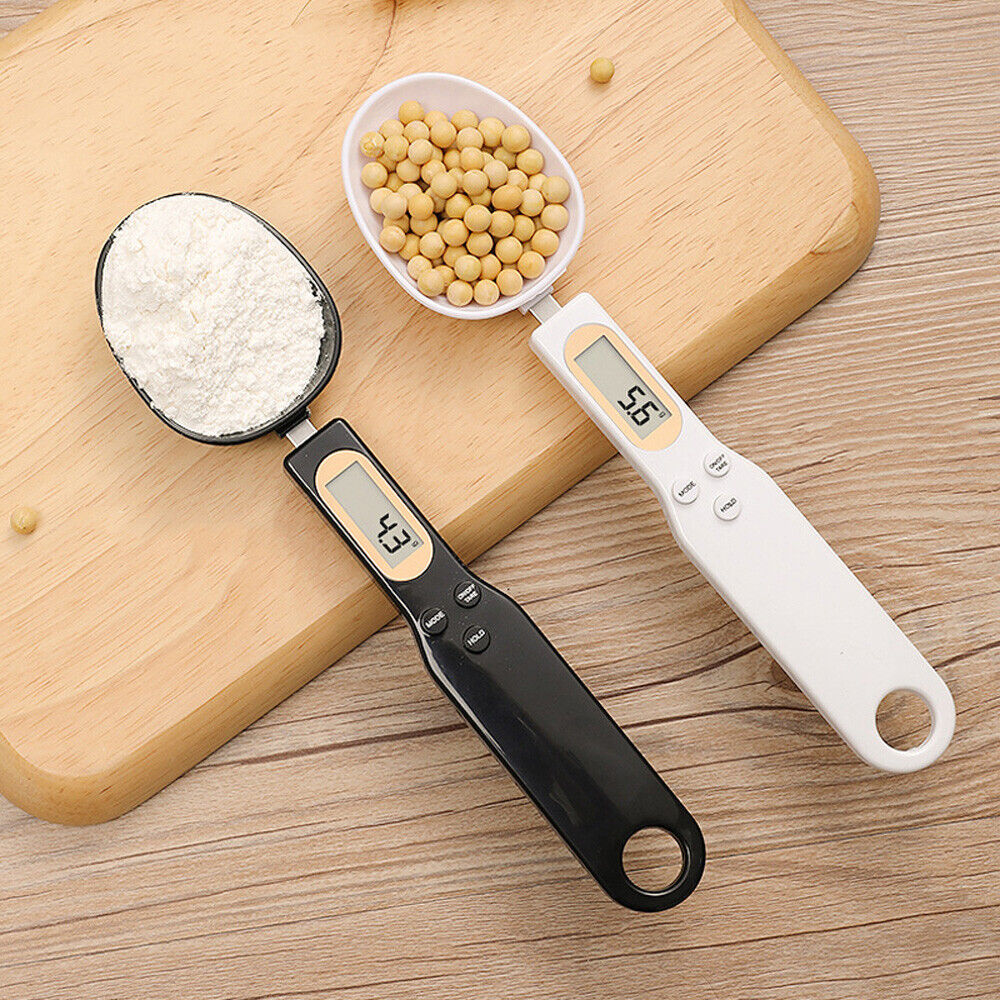 LCD digital kitchen scale spoon set on wooden board with flour and soybeans for precise measurements.